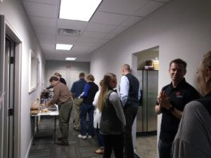 People wait to sample the selection of soups and chili at the Springville office.