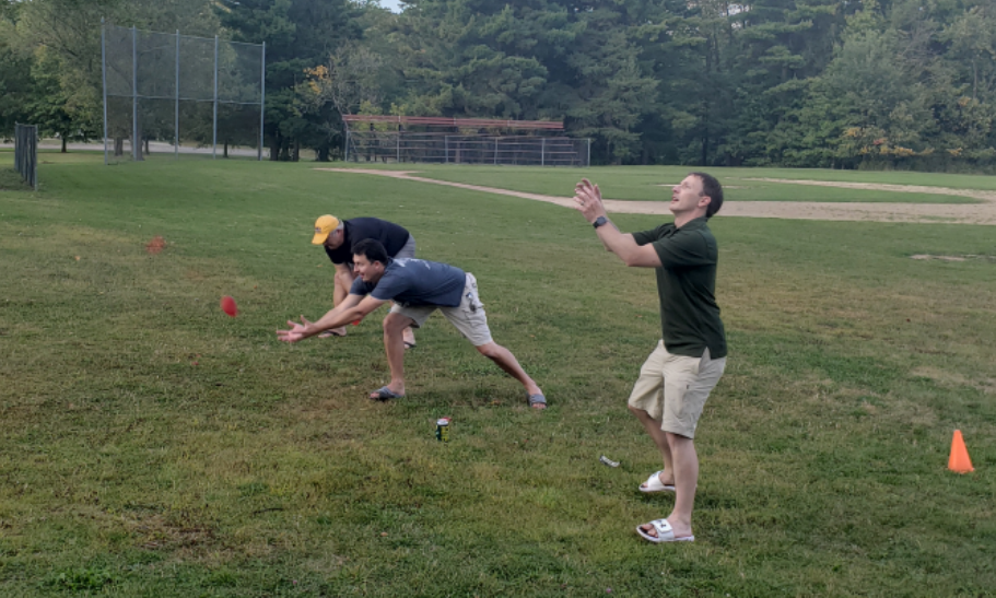 Encorus employees Jerry Sullivan, Dana Pezzimenti, and Joe Lowry try not to get soaked in the water balloon toss