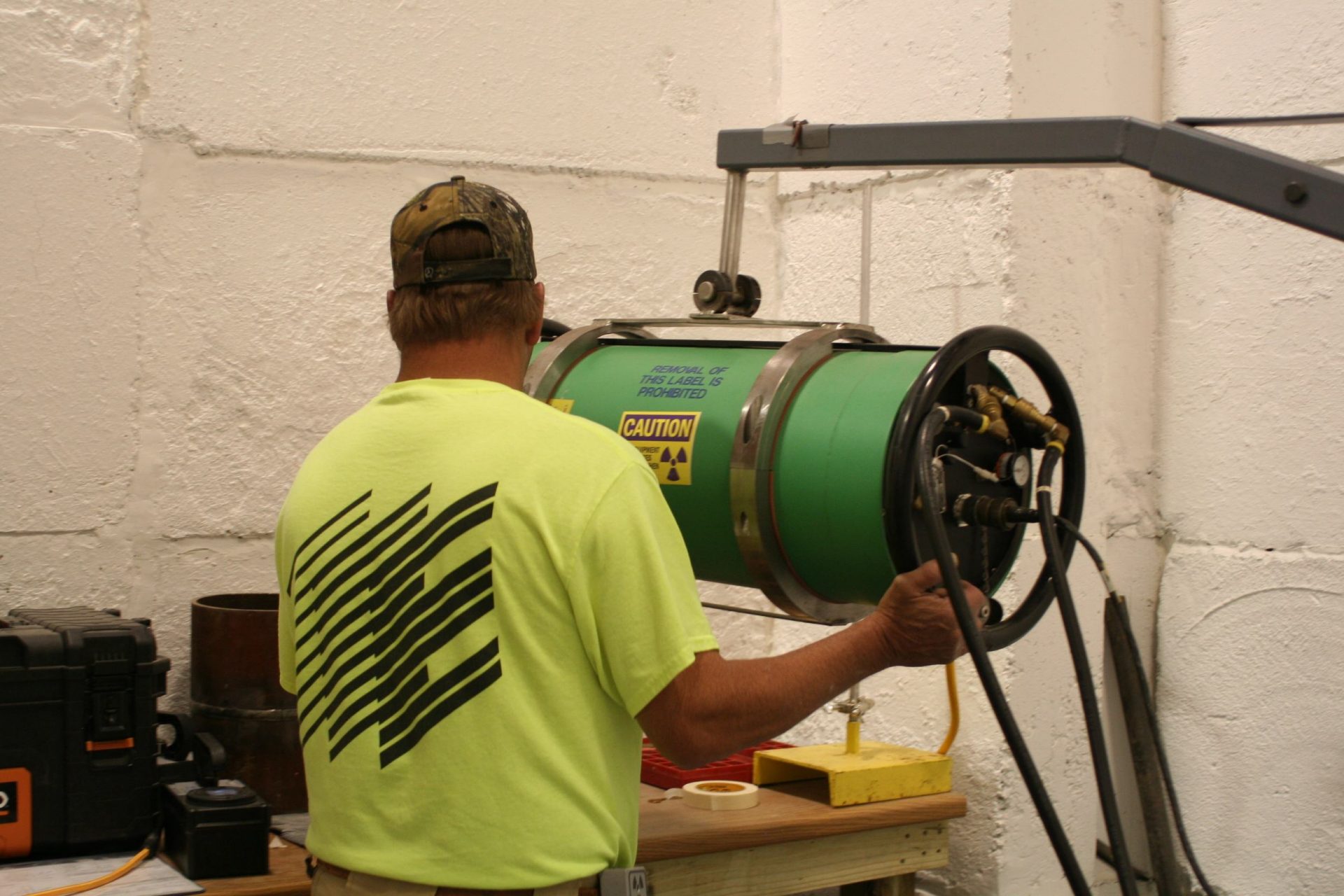 An Encorus employee prepares radiography equipment